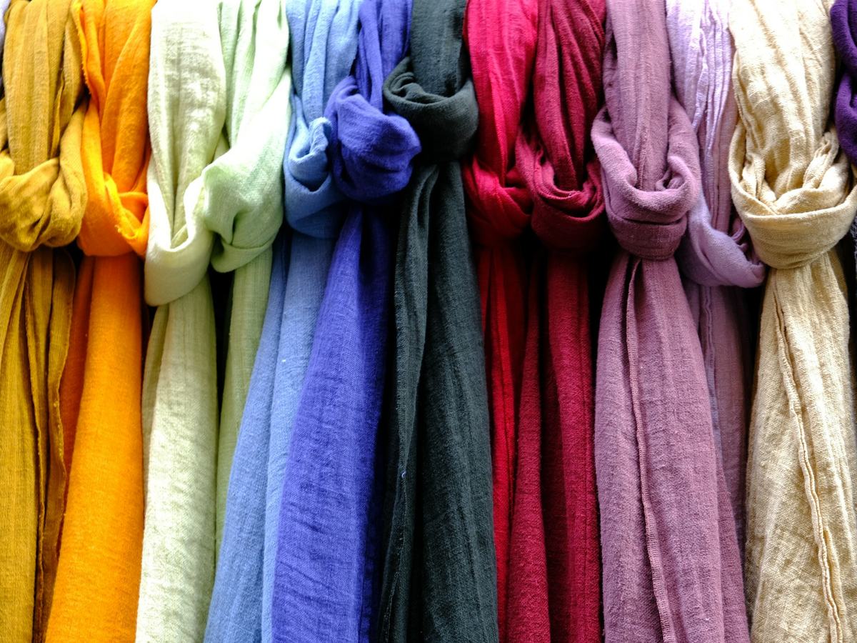 Scarves in many colors hanging side by side